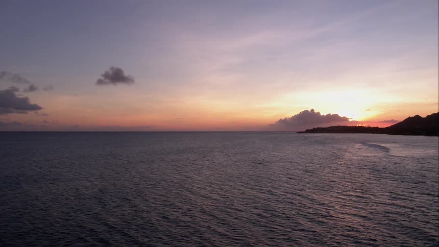 Dawn over the water with mountains in the background