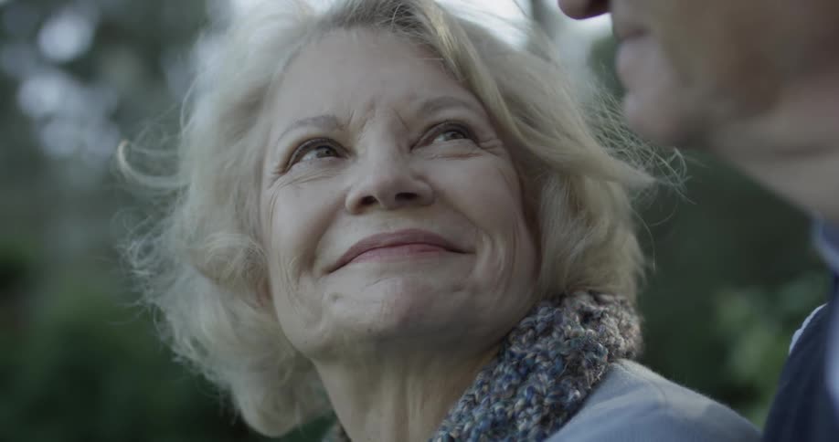 A woman is looking at a man and smiling