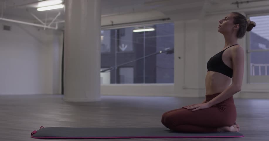 Woman Doing Yoga In Empty Building