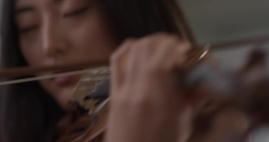A woman is playing an instrument inside