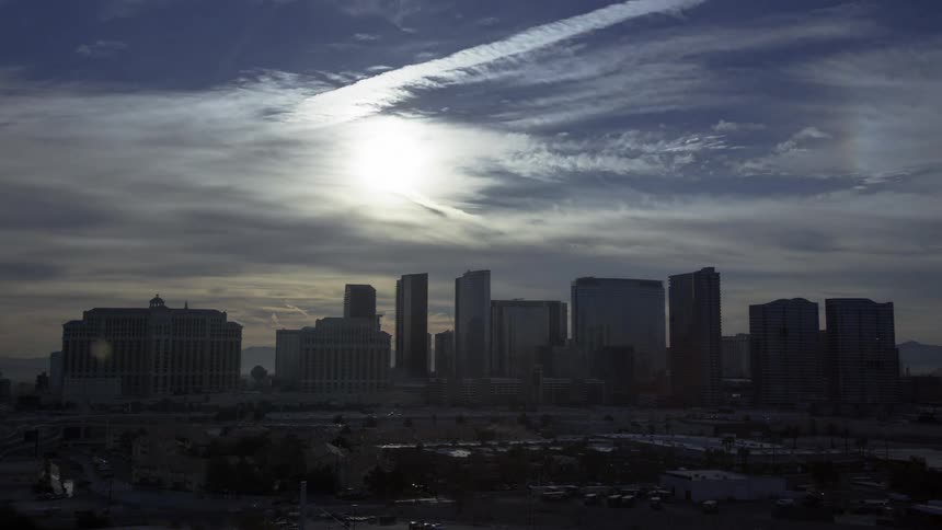 Fast motion of clouds rolling into city at dawn