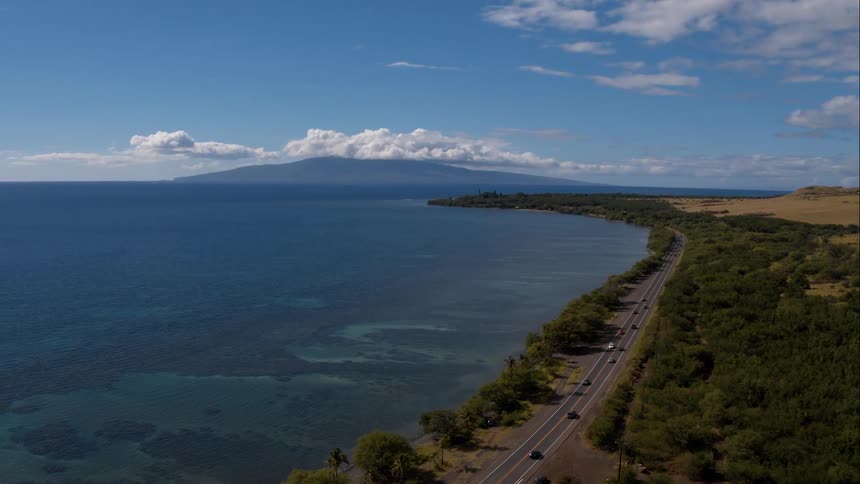 A busy highway borders calm seas and the plains