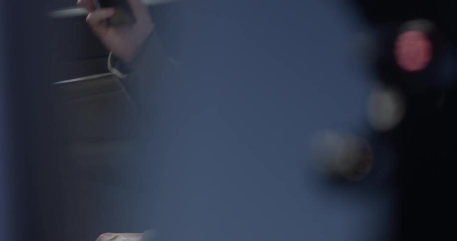 Closeup of a man in a car taking his phone out of his pocket and answering it