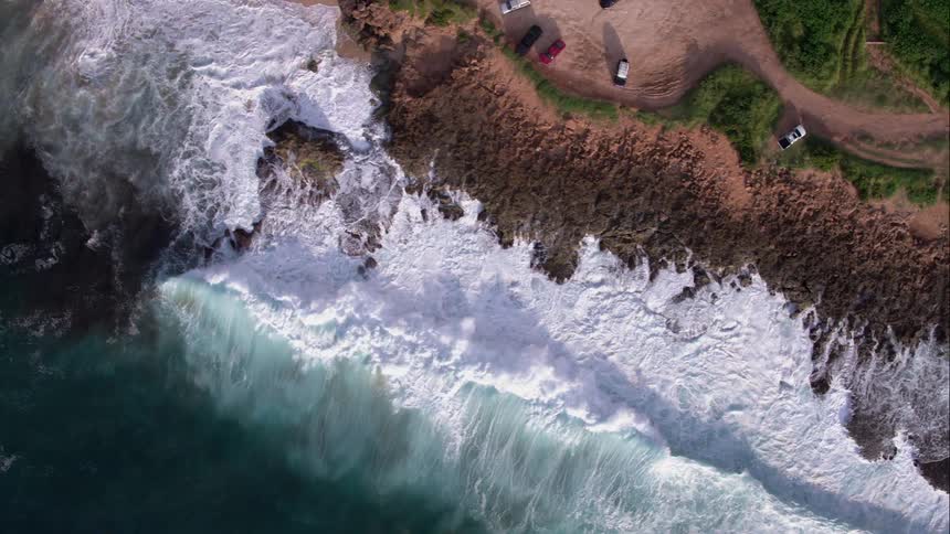 Aerial shot of waves crashing on the beach