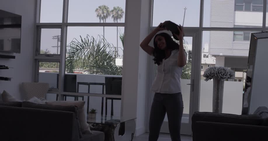 Woman in a room tries out a vr headset