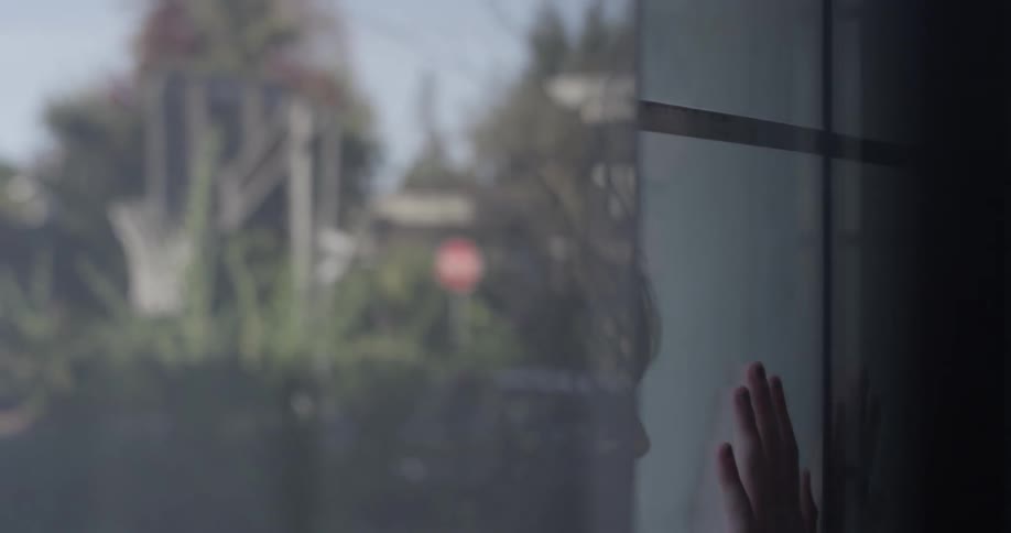Two children play game on the window that separates them