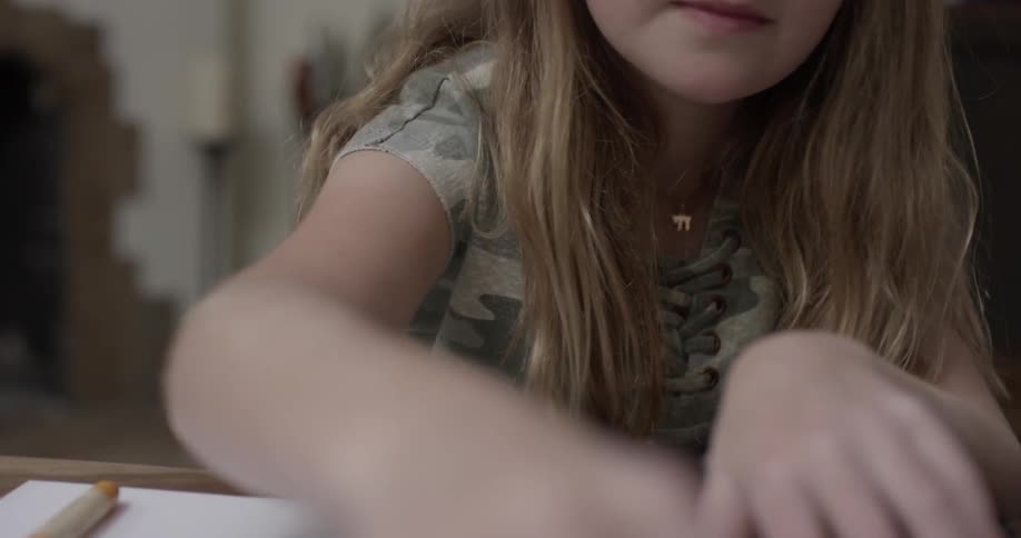 Young girl drawing and coloring a picture