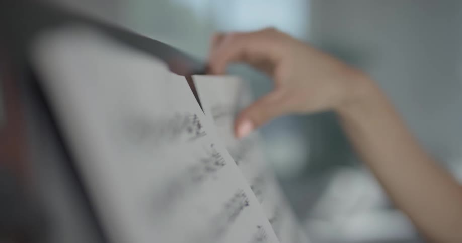 Woman puts sheet music on a stand