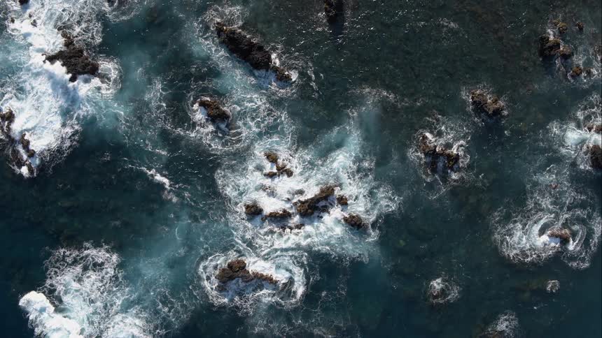 Body of water with large rocks and waves breaking