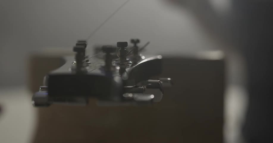 Someone is using a tool on a guitar