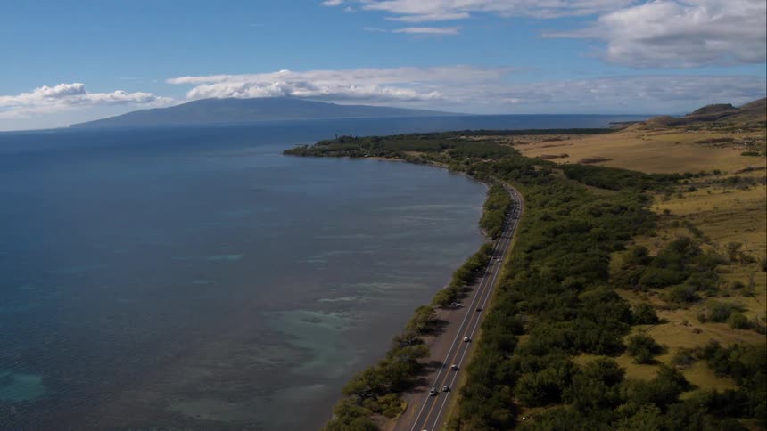 An aerial view of a road next to the ocean
