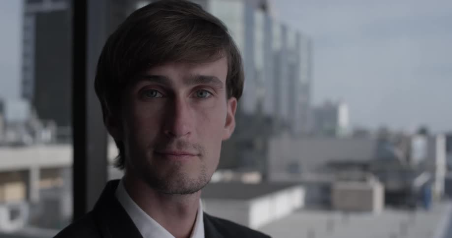 Business man looks straight at the camera