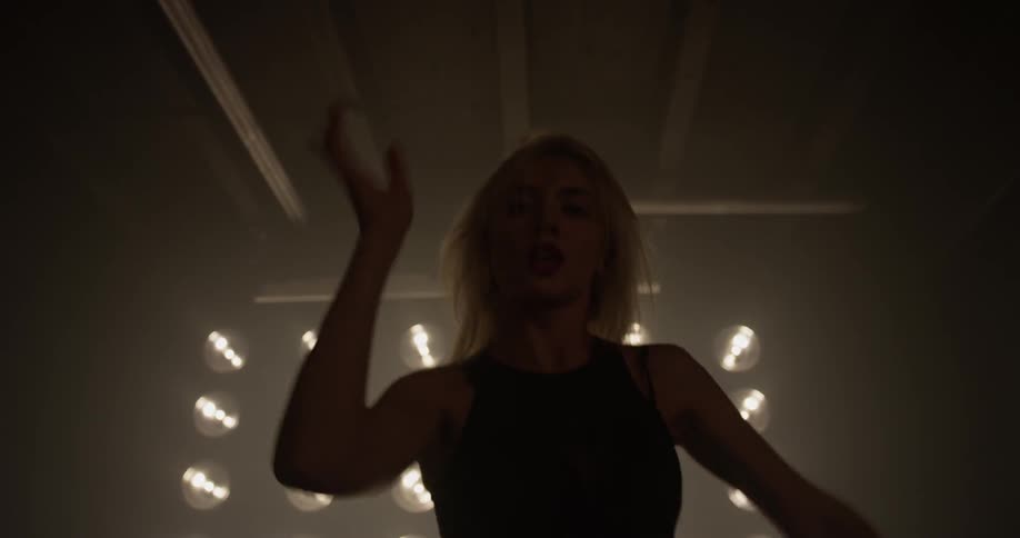 A woman is dancing in a room