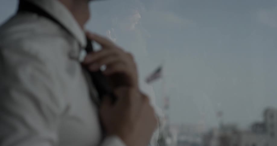 A man is fixing his tie