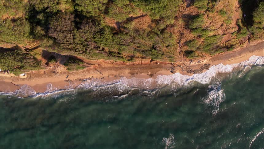Aerial shot of a car trail overlooking the ocean