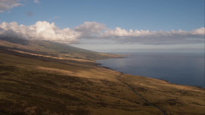 Aerial shot of plains next to an ocean