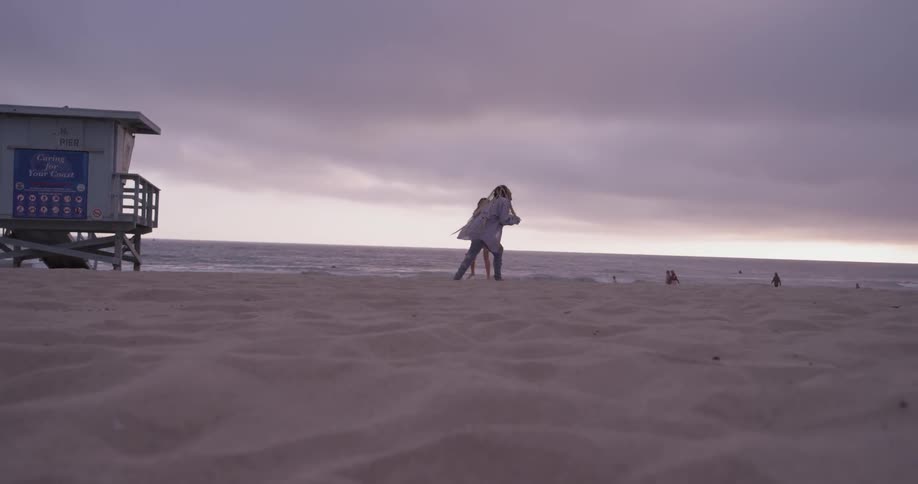 Two women playing football on the beach