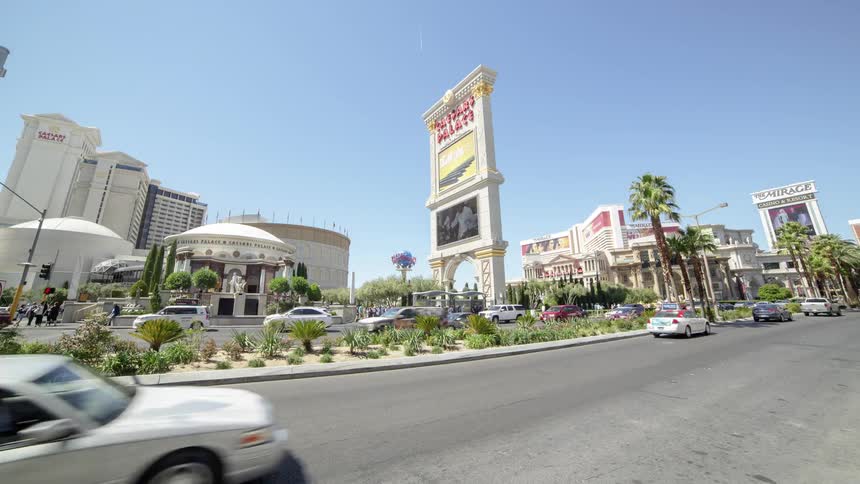 Cars pass by buildings
