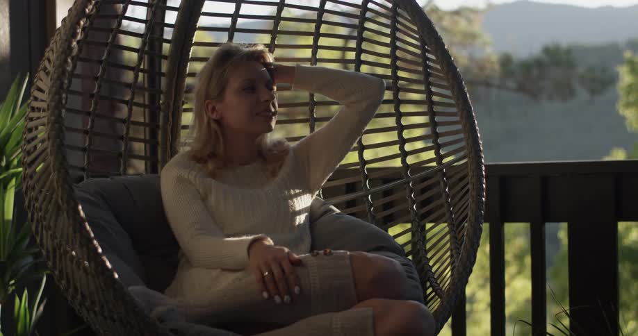 Woman sitting in a swing outdoors
