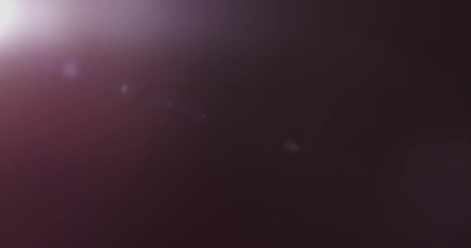 Single light shines brightly in a dark room