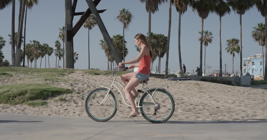 A woman is riding a bicycle outside