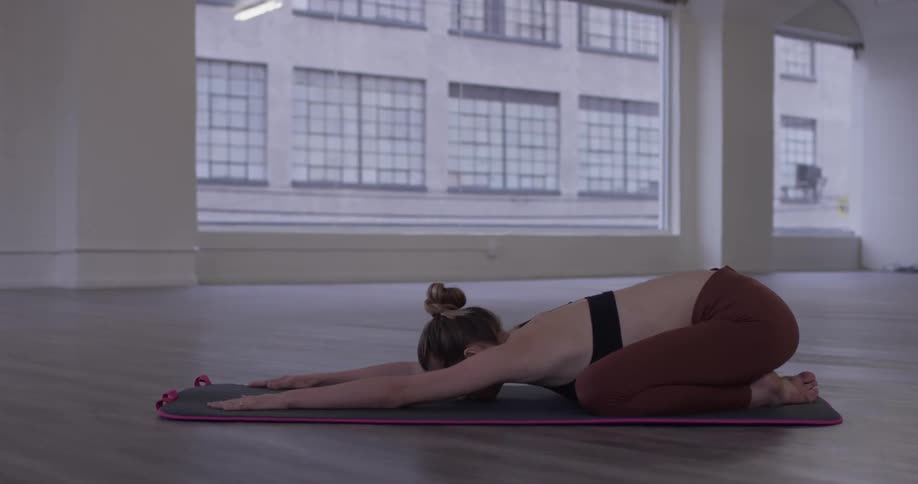 A woman stretching on a yoga mat
