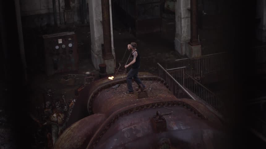 A person swings a flaming torch on a chain