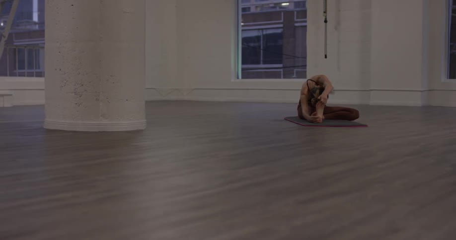 Woman Doing Yoga In Empty Building
