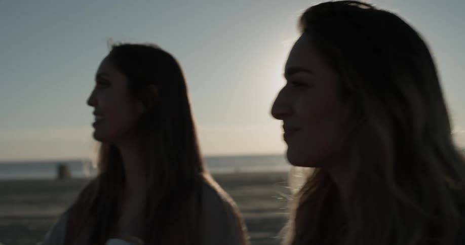 Two women eating ice cream on the beach