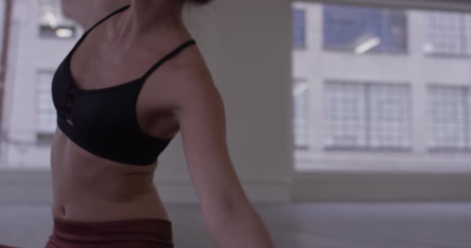 A woman is stretching indoors