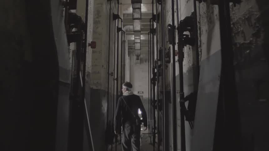 A man is walking through a building