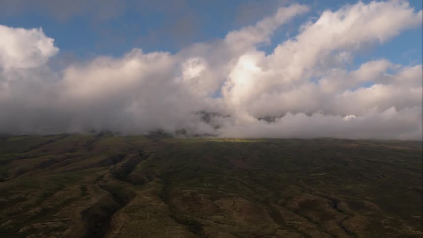Aerial shot of clouds over a rolling plains