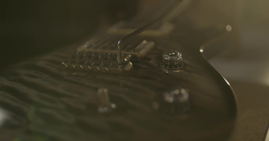 Guitar with whammy bar laying on table