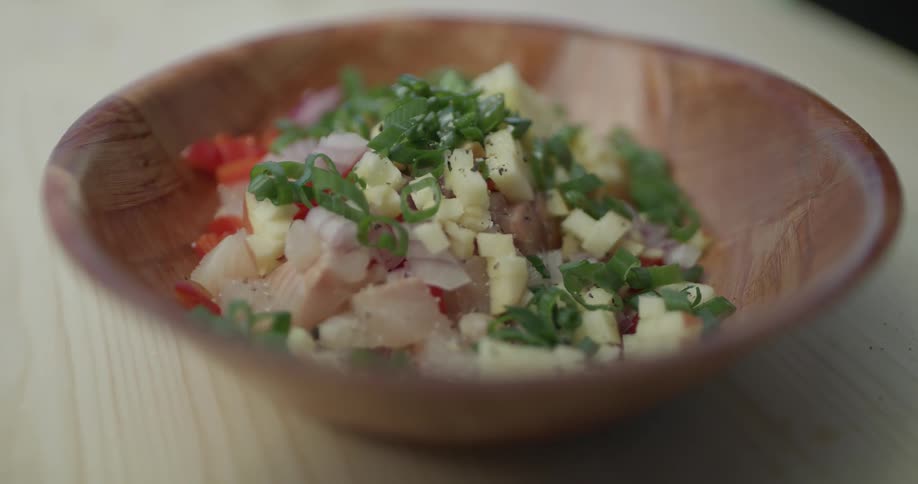 Salt being poured onto a salad