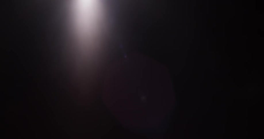 Light appears from the darkness and slowly moves to the left