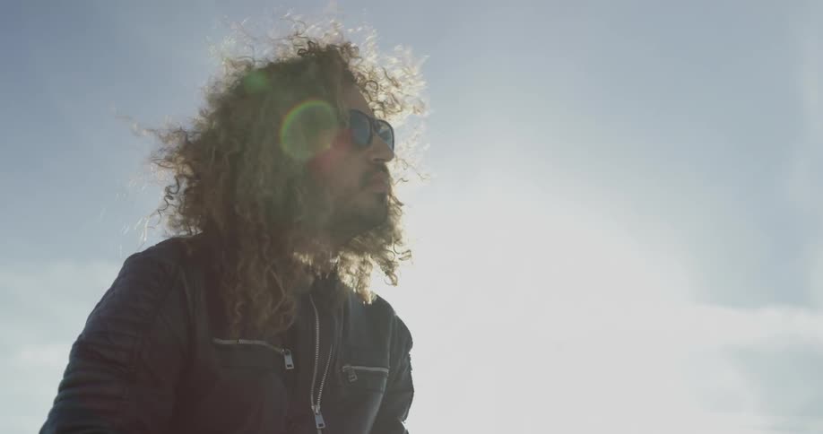 Man with sunglasses moves around under the midday sun