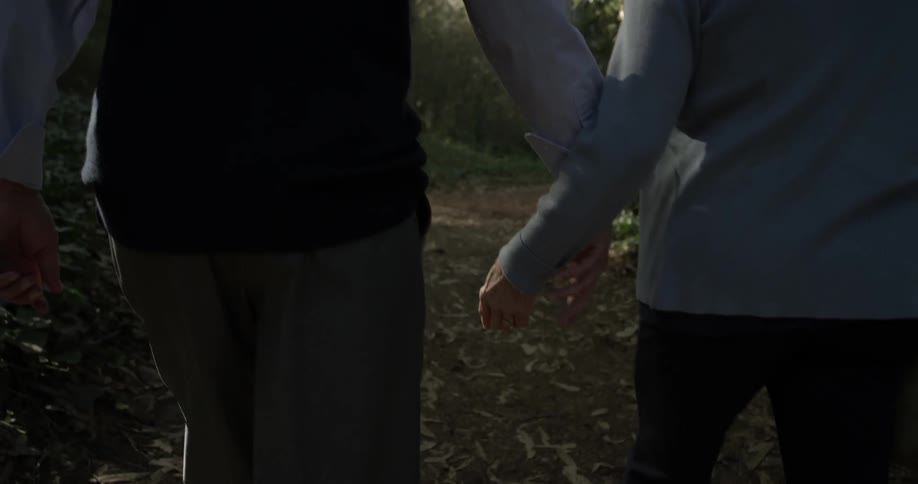 A woman and man are walking outside during daytime