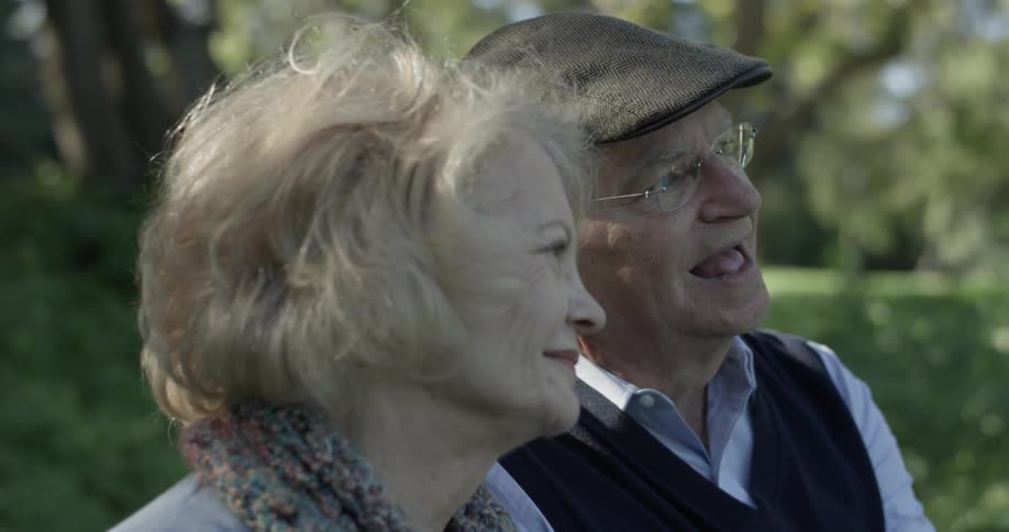 A man and woman smiling at each other outdoors