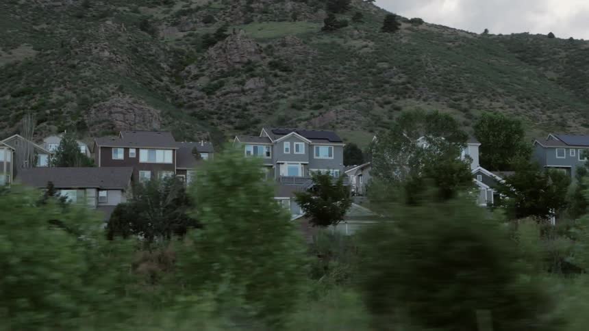 Driving by a residential area with many two story houses