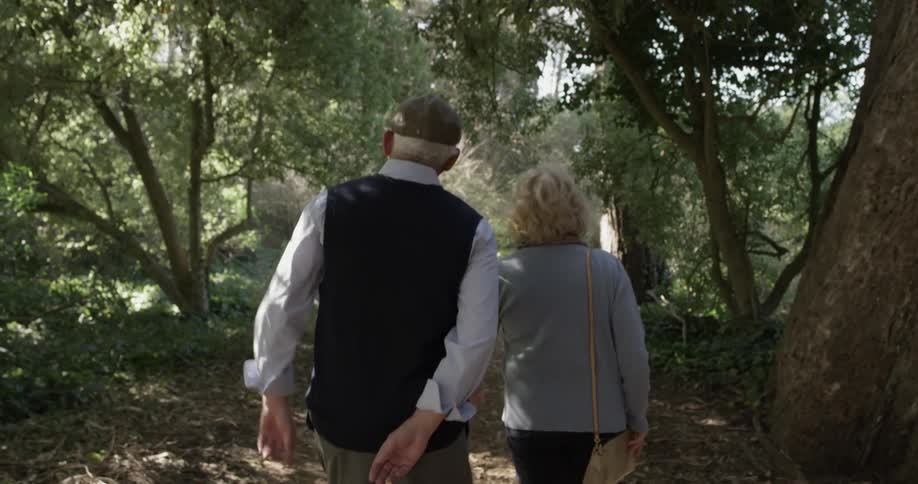 A man and woman are walking outdoors together