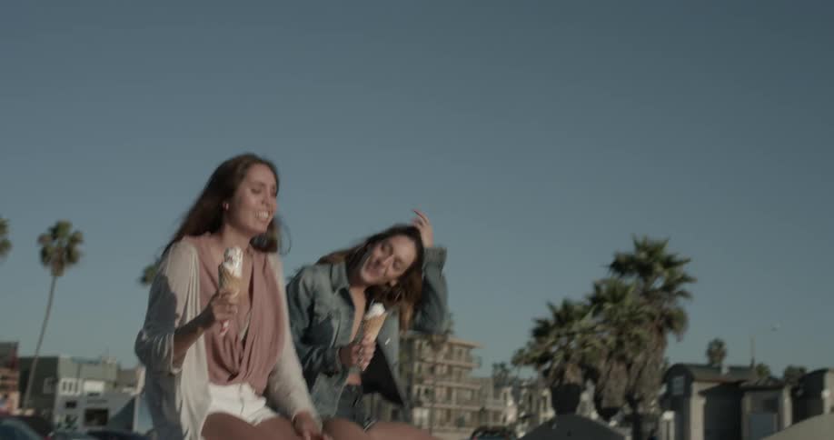 Two woman eating ice cream cones