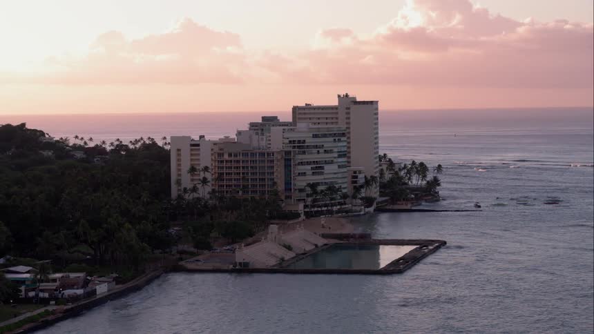 Aerial camera of a hotel by the sea at dusk