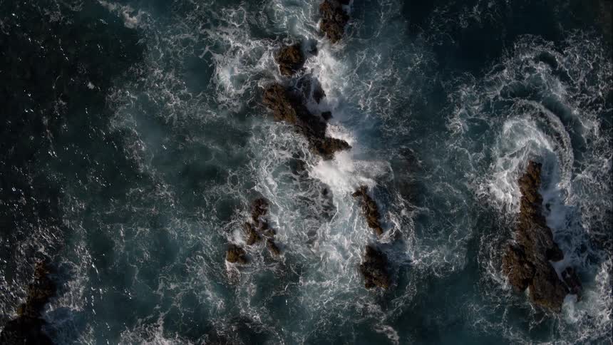 Waves splash among rocks