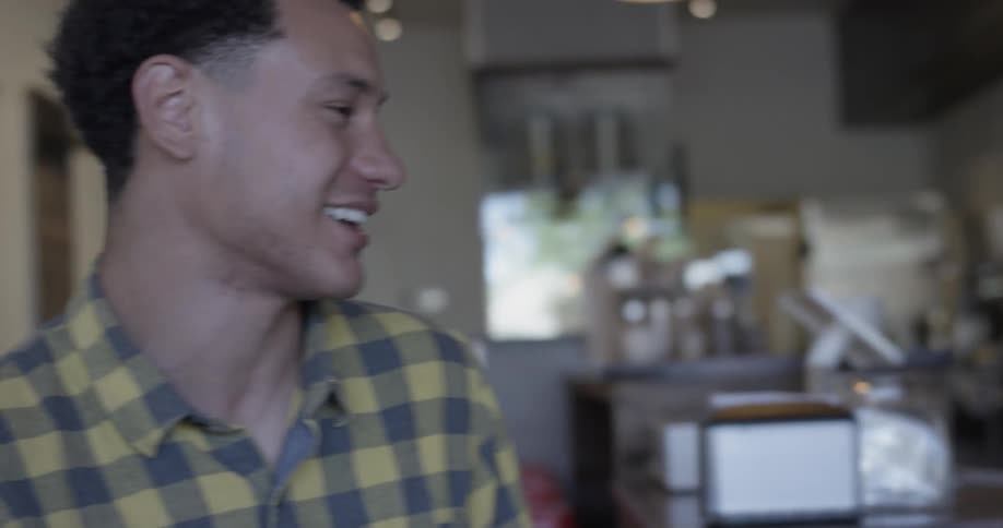 Woman and man laugh together in a coffee shop