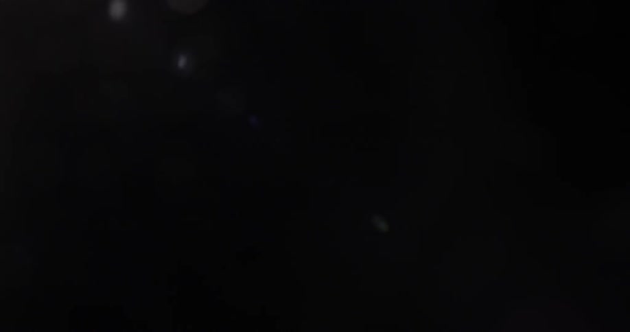 White dots of light slightly permeate black background