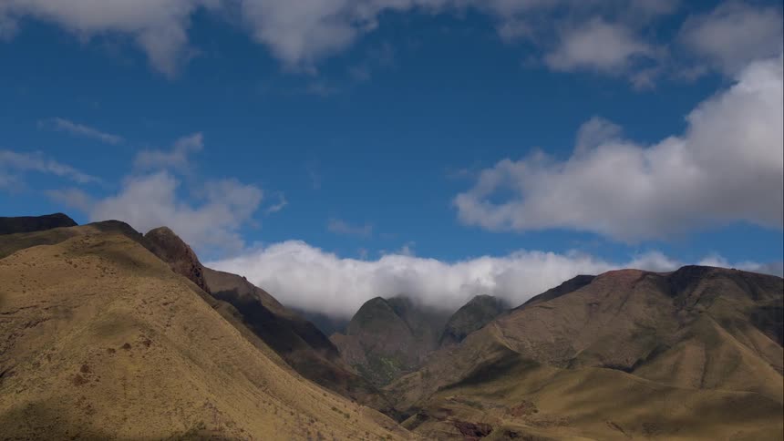 Aerial shot of clouds over some hills