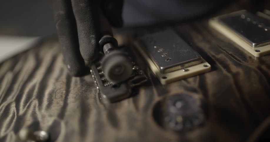 Man Making Guitar In Workshop