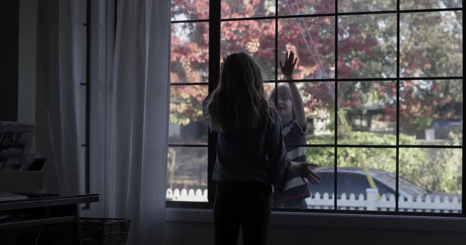 Kids playing through a living room window