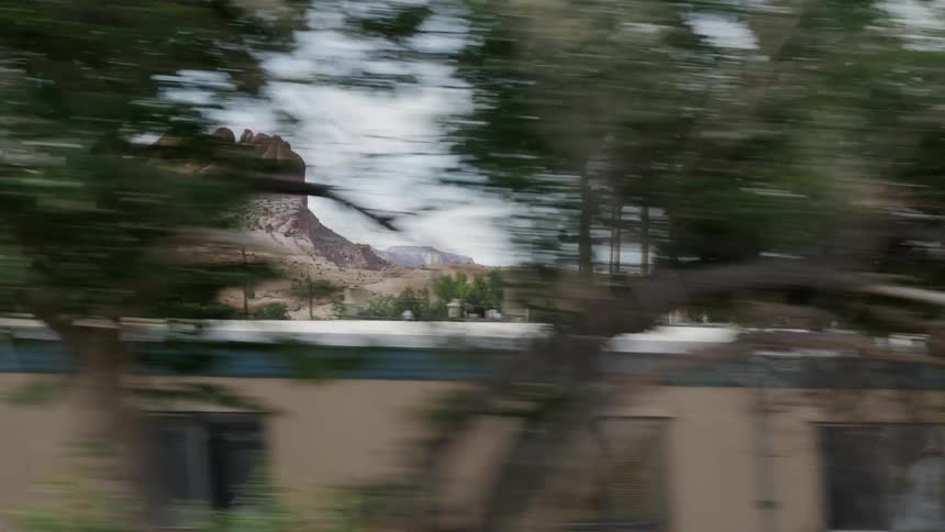 A car is driving through a desert