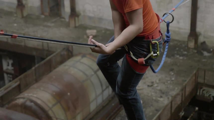 A person is climbing across a rope